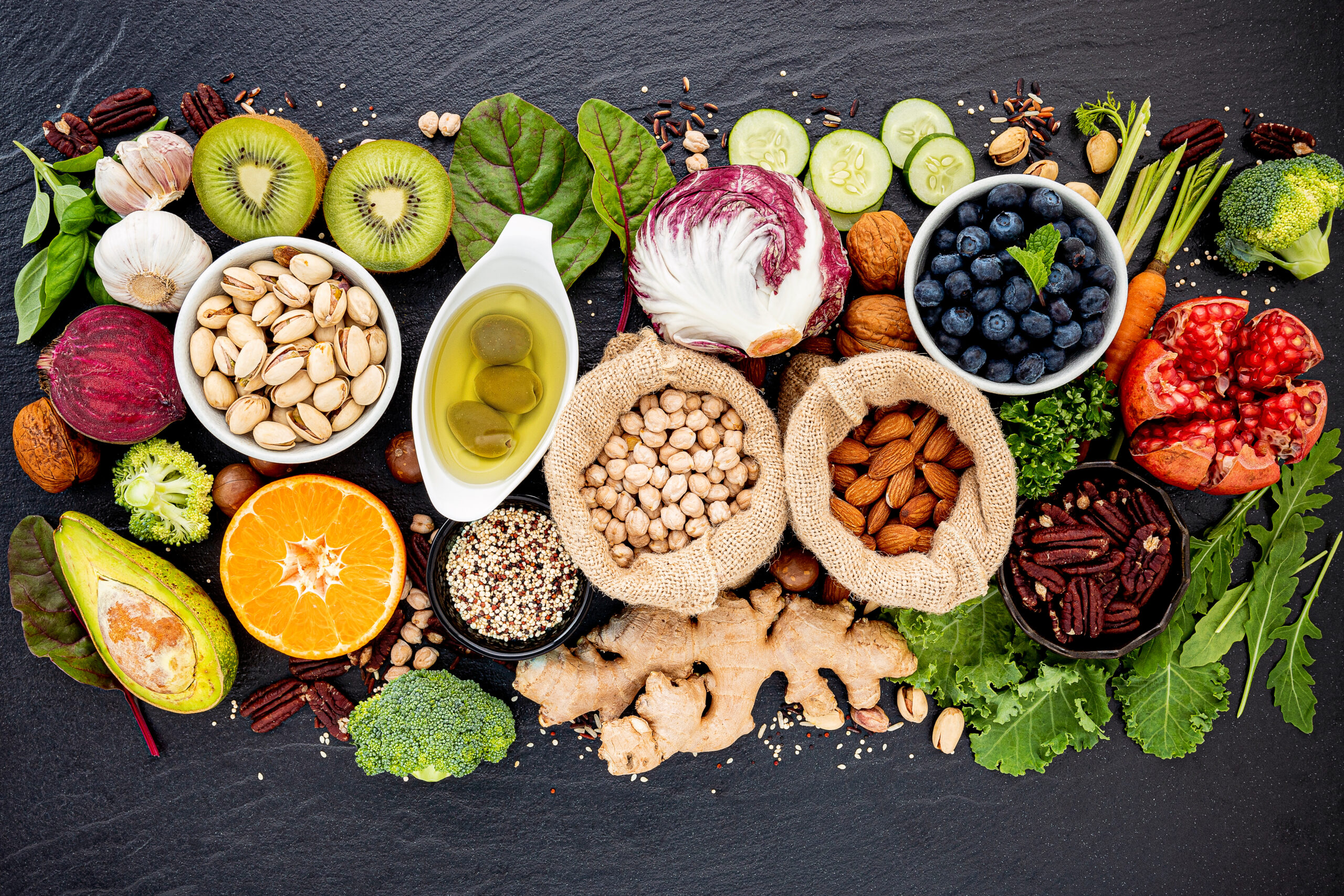 Ingredients for the healthy foods selection. The concept of healthy food set up on dark stone background.