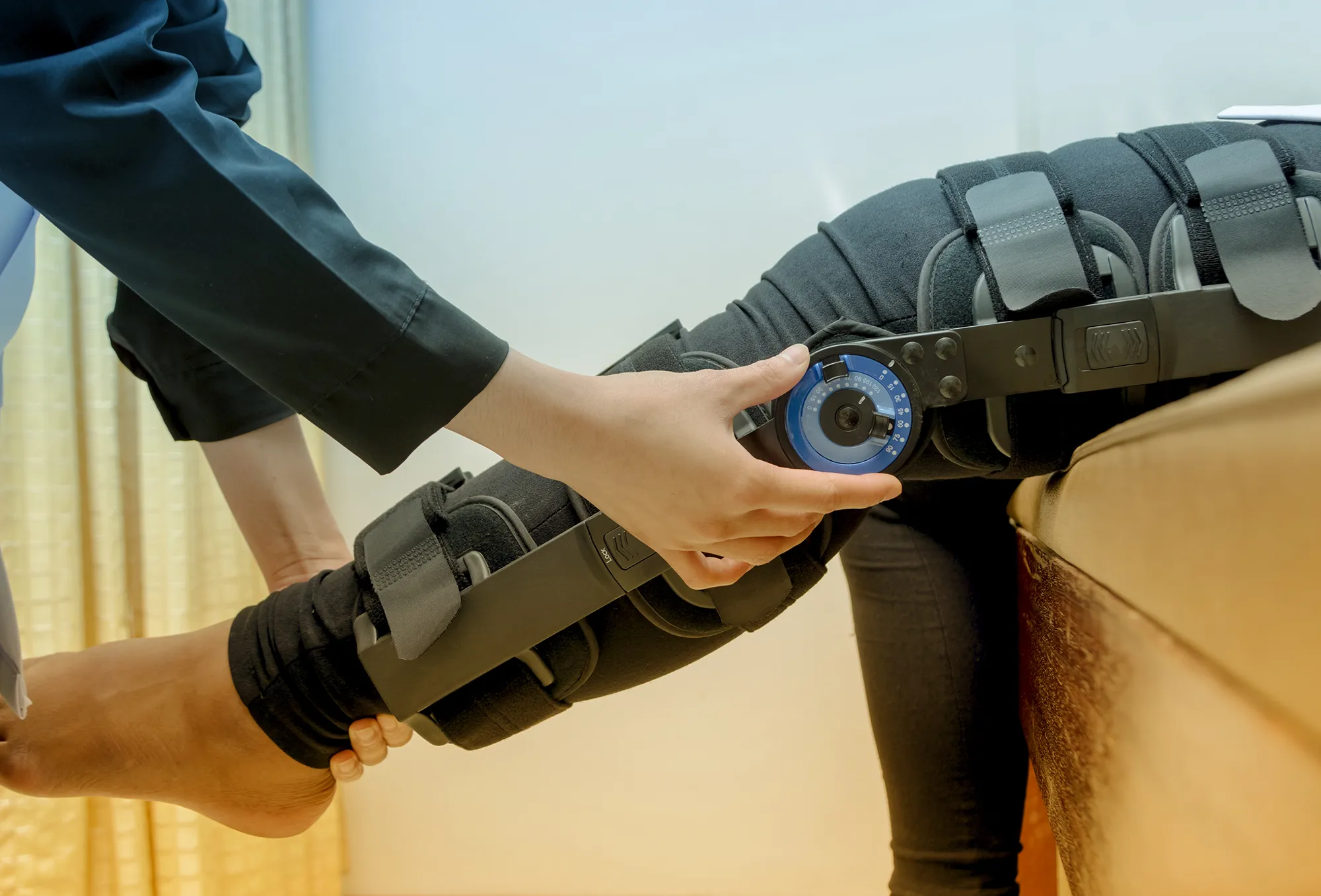 Physiotherapist adjust knee braces on patient 's leg,Rehabilitation for knee injury
