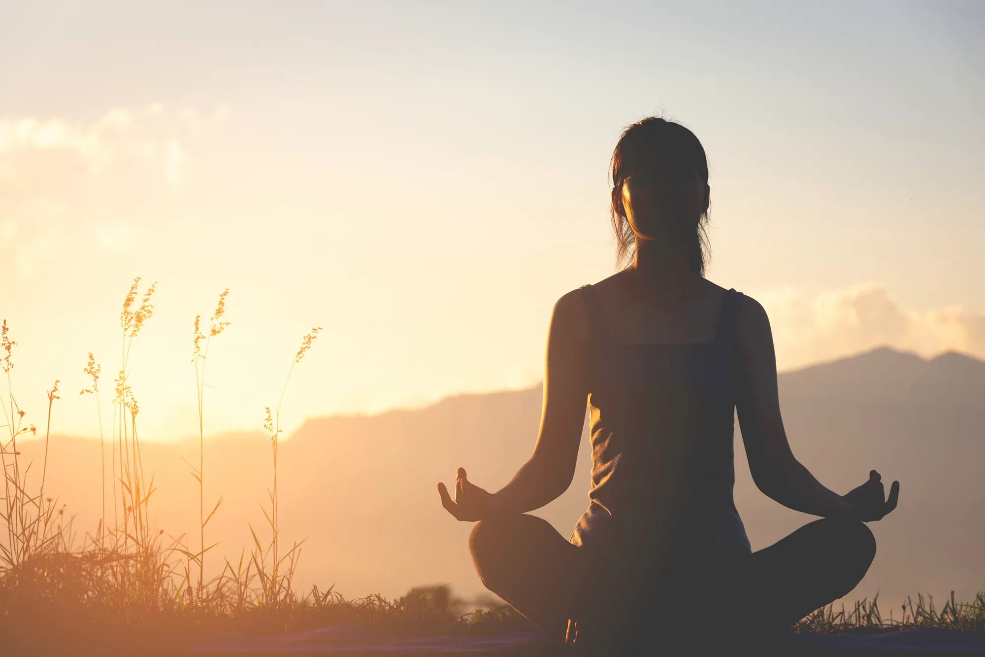 A girl meditating in the mountains