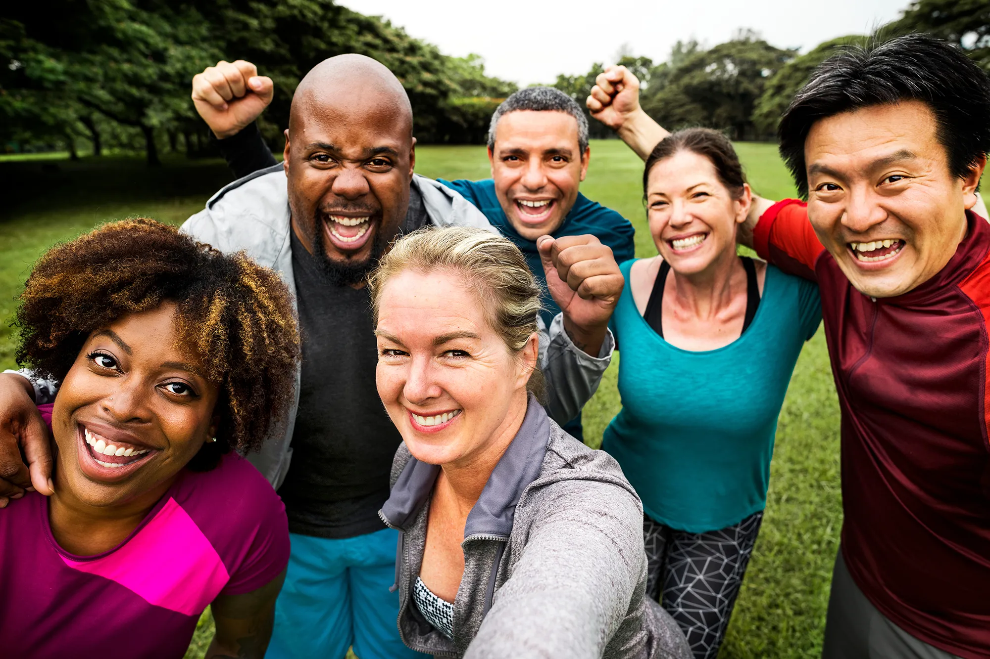 Group of cheerful diverse friends in the park
