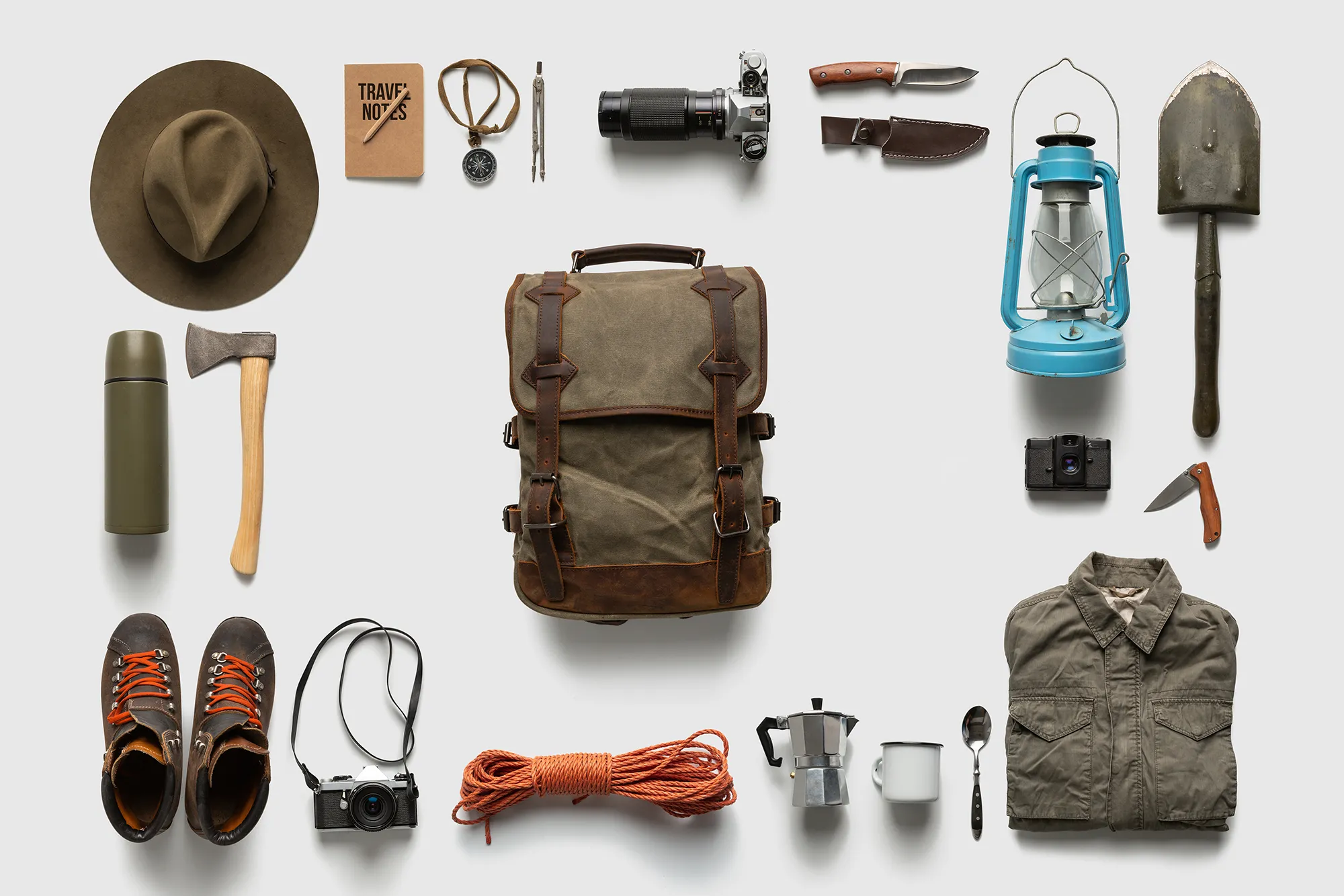 Packing backpack for a trip concept with traveler items isolated on white background
