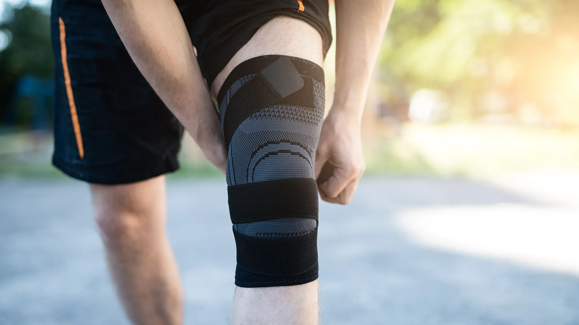 Knee support brace on male legs
