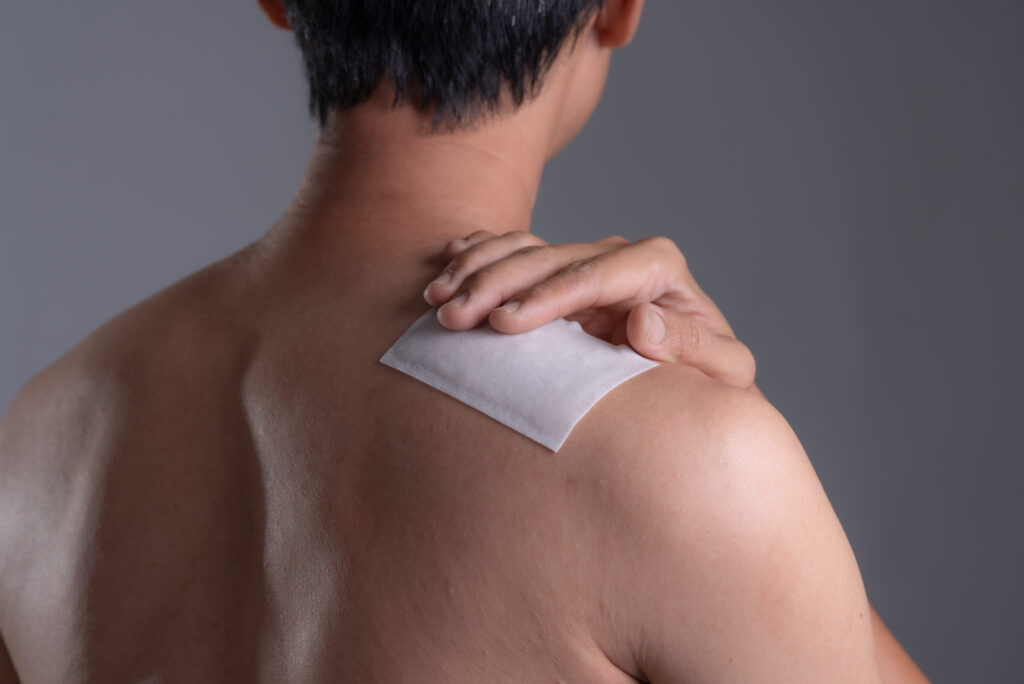 Medicated pain relief patch with man pain shoulders,office syndrome,Health problems from overworked concept.