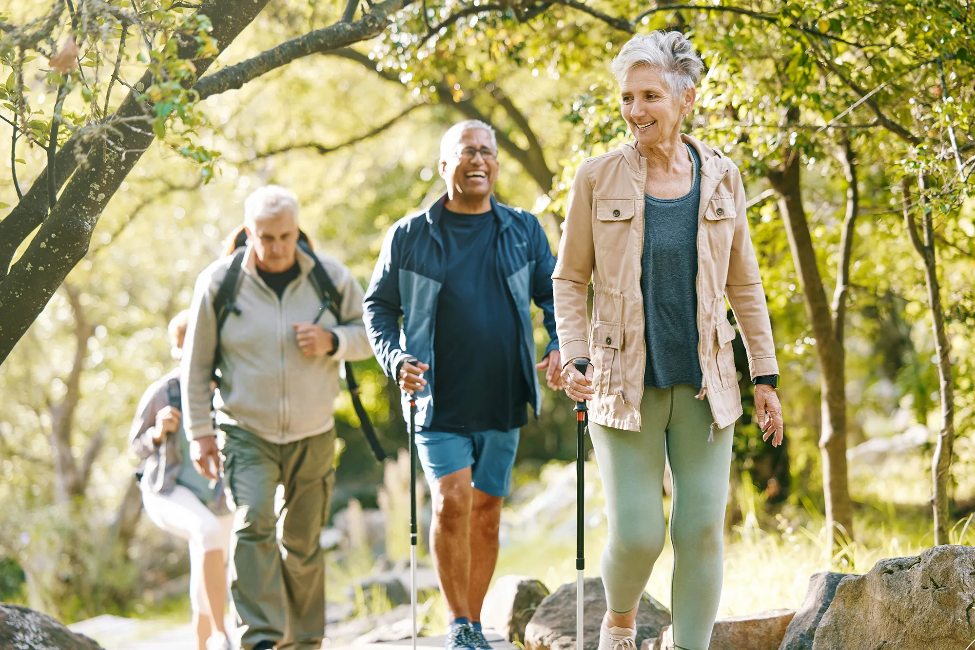 Hiking, elderly and people, happy outdoor with nature, fitness and fun in park, exercise group trekking in Boston. Diversity, friends and happiness with hike, active lifestyle motivation and senior.
