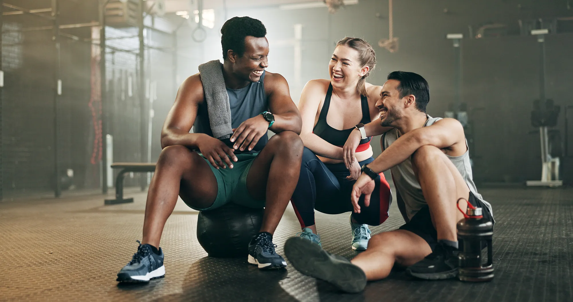 Fitness, group and conversation in gym with confidence, workout and exercise class. Diversity, friends talk and wellness portrait of athlete with coach ready for training and sport at a health club 
